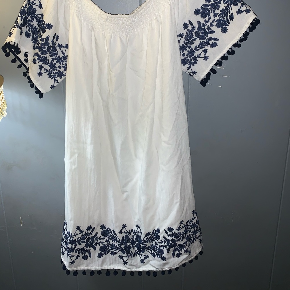 White dress with blue design.